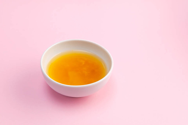 Yuja tea or yuzu tea on pink background. Selective focus, copy space. Popular Korean tea. Honey citron beverage. - 写真・画像