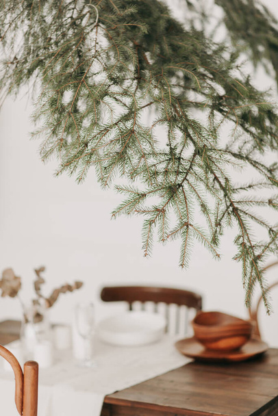 christmas aesthetics green spruce and dining table new year decor new year - Foto, Imagen