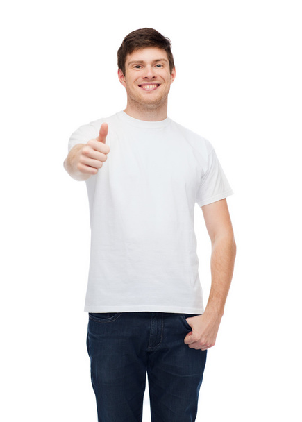 smiling man in white t-shirt showing thumbs up - Fotoğraf, Görsel