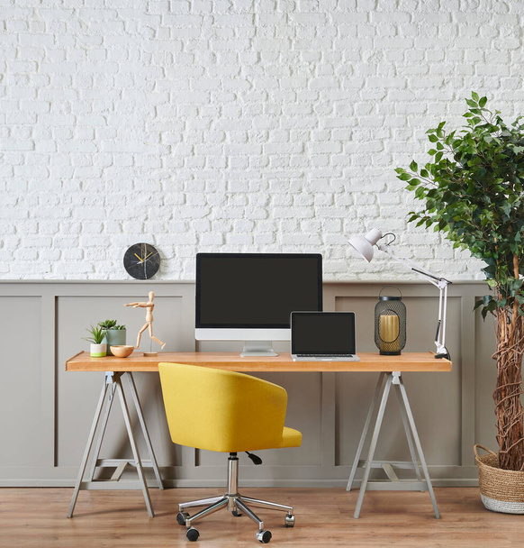 Μοντέρνο γραφείο εργασίας και ξύλινος σχεδιασμός τραπεζιού, στυλ υπολογιστή και laptop, αξεσουάρ σπιτιού, φωτιστικό και διακόσμηση καρέκλας. Λευκό τούβλο και καφέ κλασικό τοίχο φόντο. - Φωτογραφία, εικόνα