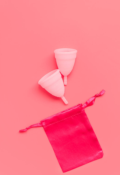Pink menstrual cup on color background, female intimate hygiene period products, top view - Photo, Image
