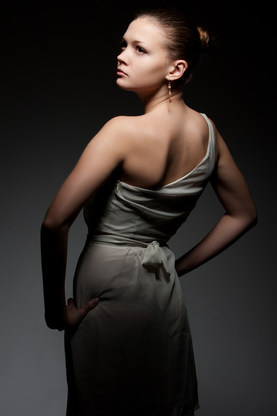 Beautiful woman posing over dark background - Photo, Image