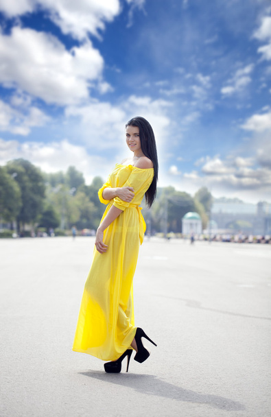 Beautiful young woman in yellow dress - Фото, зображення