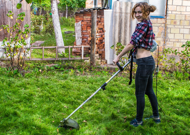 Woman in Plaid Shirt Mowing Lawn - Photo, Image