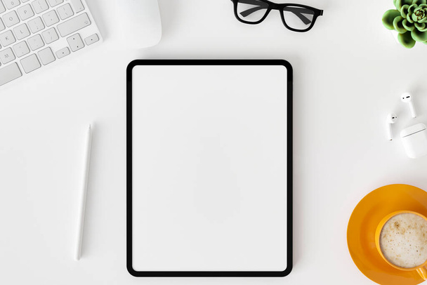 Top view of blank screen tablet on white working desk background. - Φωτογραφία, εικόνα