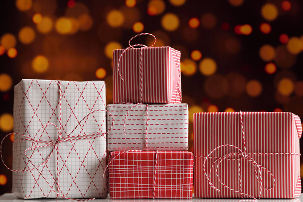 Christmas New Year gift boxes on blurred lights background. - Fotoğraf, Görsel