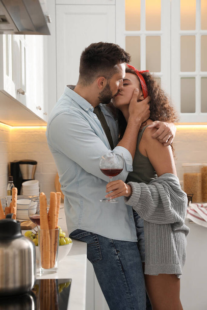 Lovely couple enjoying time together during romantic dinner in kitchen - Photo, image