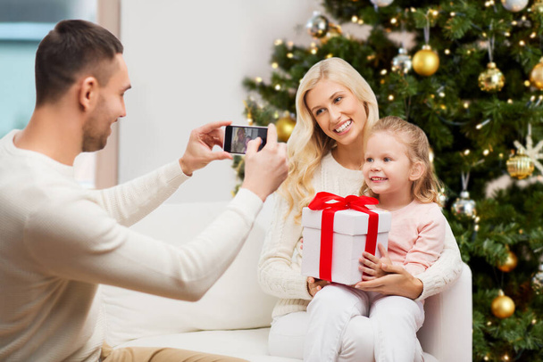 family taking picture with smartphone at christmas - Zdjęcie, obraz