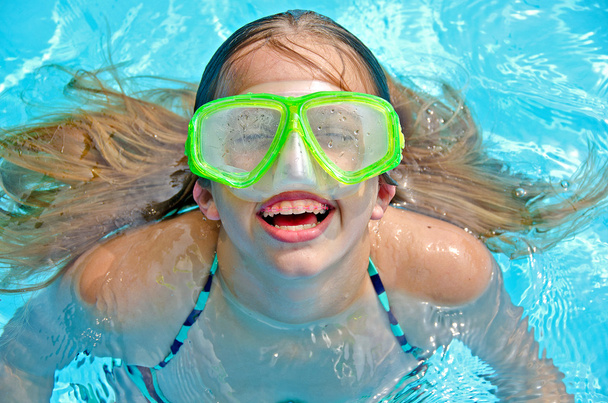 Young girl with braces in pool - Foto, imagen
