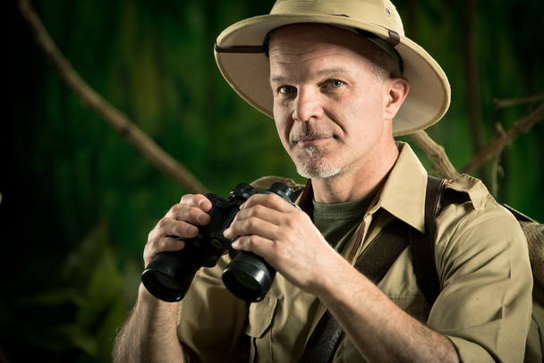 Adventurer in the jungle with binoculars - Φωτογραφία, εικόνα