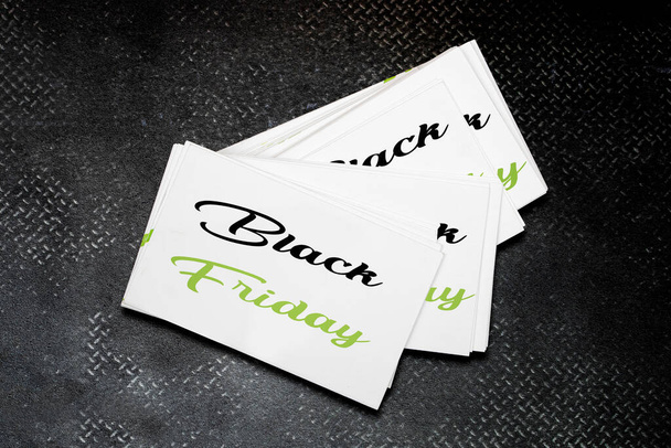 Black Friday concept on white blank visit cards on black grey leather texture background. ready to use for your design - Photo, Image