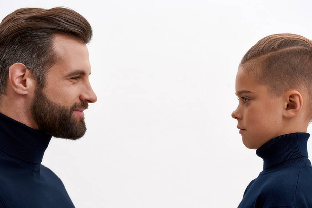 Smiling father and small son look in eyes facing - Photo, image