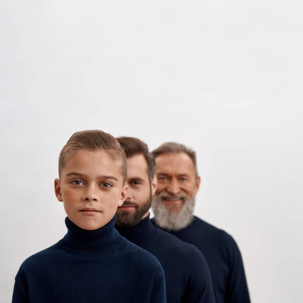 Portrait of three generations of men on white background - Foto, afbeelding