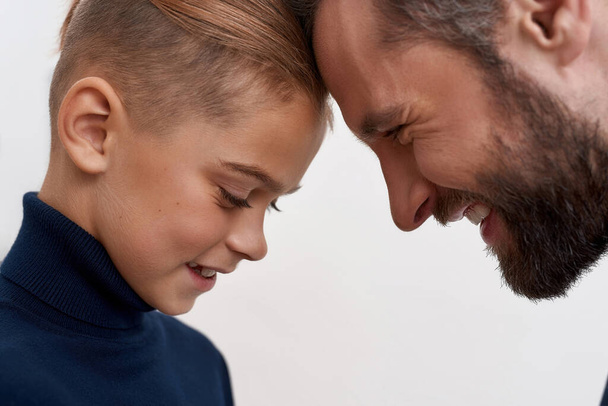 Close up of happy father and small son touch foreheads - Photo, image