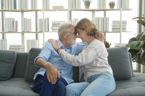 Happy Caucasian senior couple relaxing in living room  at home - Фото, изображение