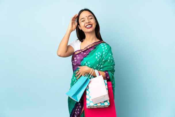 Young Indian woman with shopping bags smiling a lot - Photo, image