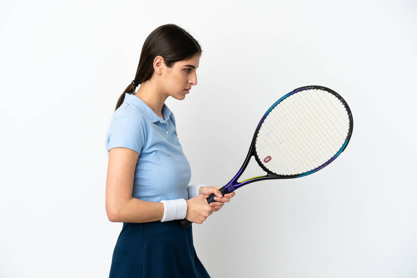 Young caucasian woman isolated on white background playing tennis - Valokuva, kuva