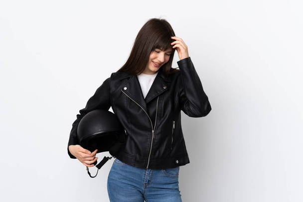 Woman holding a motorcycle helmet isolated on white background laughing - Fotó, kép