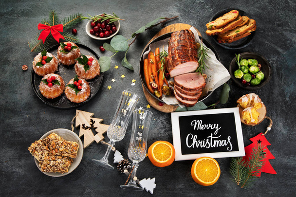 Christmas dinner table setting on dark background. Holiday season concept. Top view, flat lay, copy space - Foto, Imagem