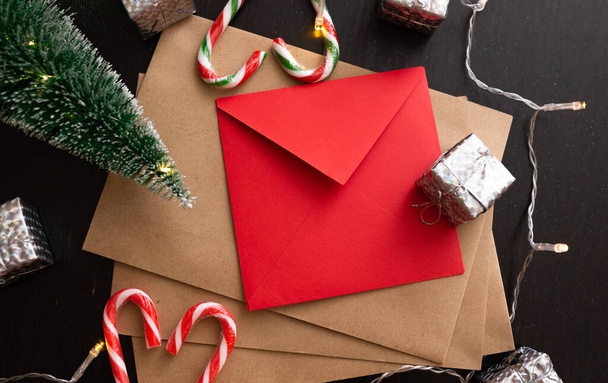 new Year background with New Year envelopes and accessories on a black background with a garland - 写真・画像