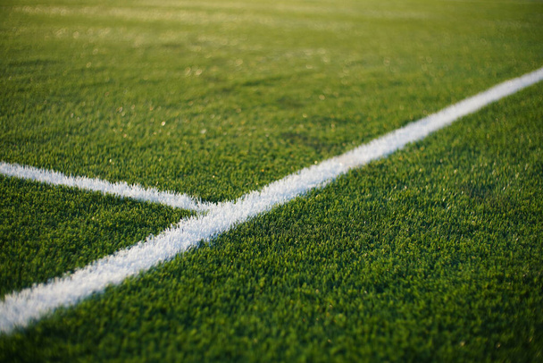 closeup of a green synthetic grass surface on a soccer ground, european football field with artificial grass - Valokuva, kuva