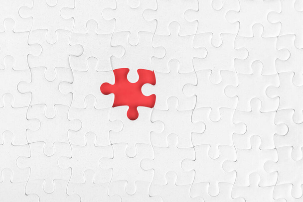 White blank jigsaw puzzle without one piece. Missing part and incompleteness theme - Foto, Bild
