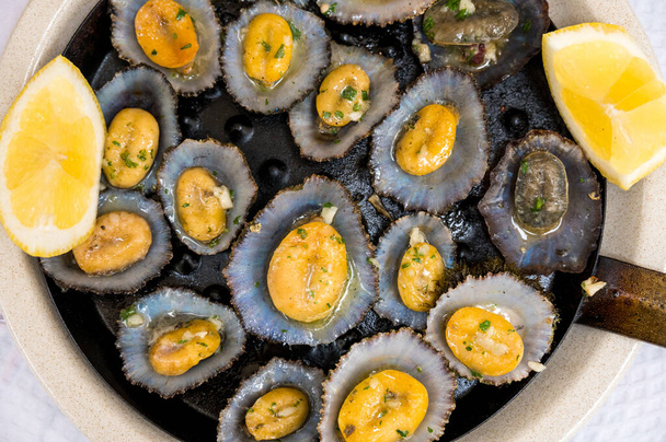 tasty seafood - grilled limpets served with lemon. - Photo, Image