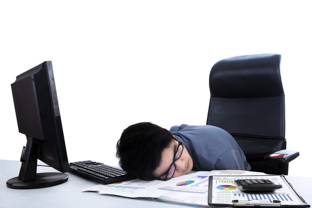 Tired businessman sleeping at workplace - Foto, imagen