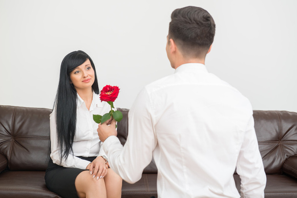 Businessman giving a flower to pretty colleague - Photo, Image
