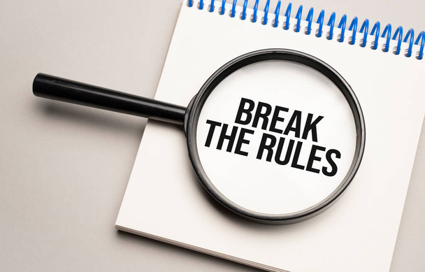 Magnifying glass with the word Break the Rules on chart background - Foto, imagen