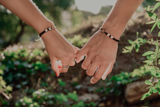 Dva zamilovaní mladí lidé se drží za ruce. - Fotografie, Obrázek