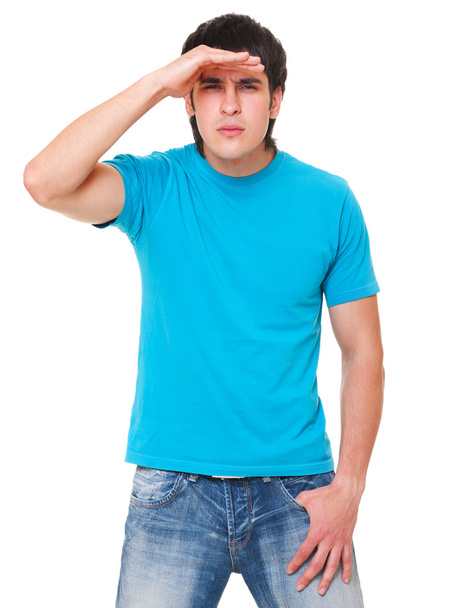 Handsome man in blue t-shirt is scrutinizing - Φωτογραφία, εικόνα