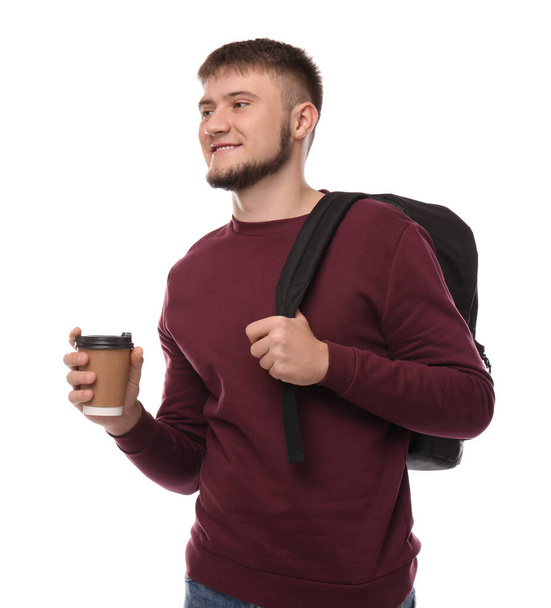 Young student with backpack and cup of coffee on white background - Photo, Image