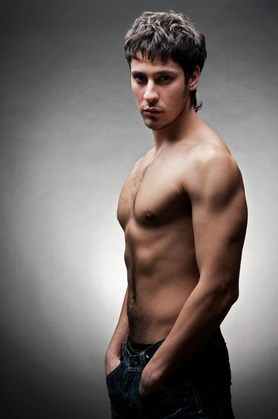 Serious young man with naked torso - Foto, imagen