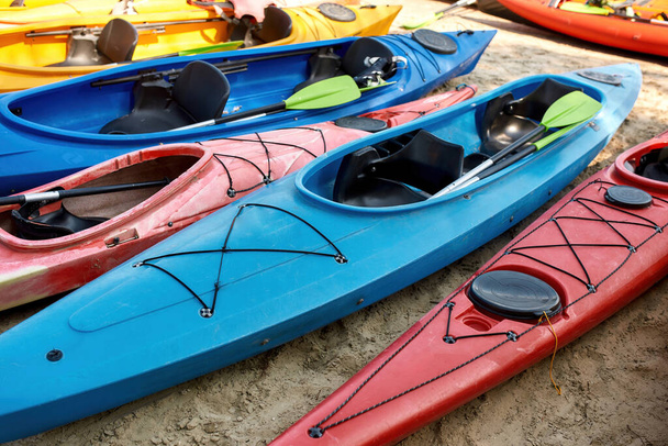Collection of kayaks with paddles on coast - Fotoğraf, Görsel