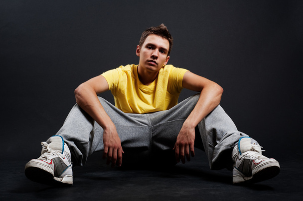 Serious guy sitting on the floor - Photo, Image