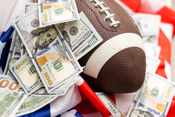Money and rugby ball on american flag background, closeup. Concept of sports bet - Fotoğraf, Görsel