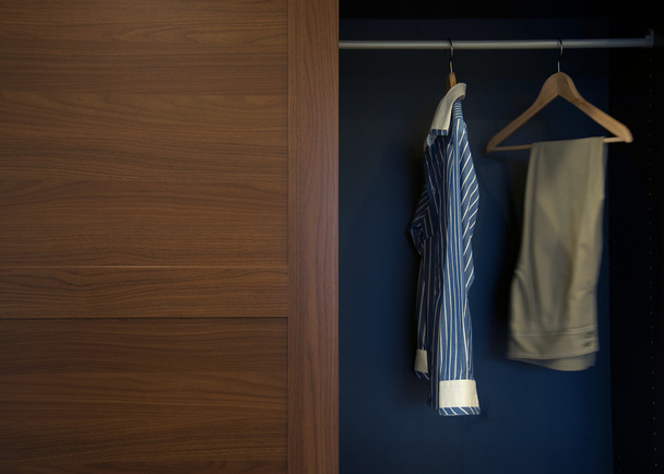 Clothes hung neatly in wardrobe wood - Photo, Image