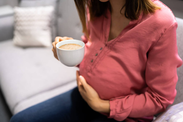 Pregnant Mother Drinking Cup Of Coffee At Home - Foto, Imagem