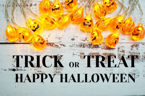 Trick or Treat typography text and Pumpkin Lights LED for Halloween Decorations on wooden background - Foto, Bild