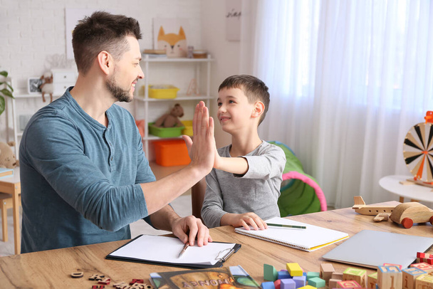 Male psychologist working with little boy in office. Autism concept - Photo, Image