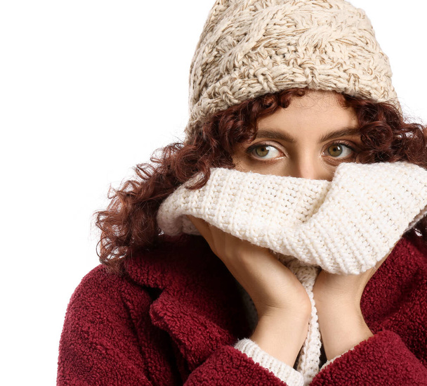 Young woman wearing knitted hat and scarf on white background - Foto, Bild