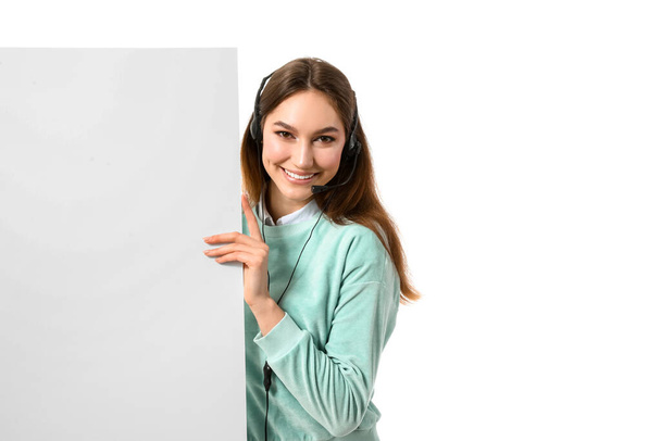 Female technical support agent with blank poster on white background - Valokuva, kuva