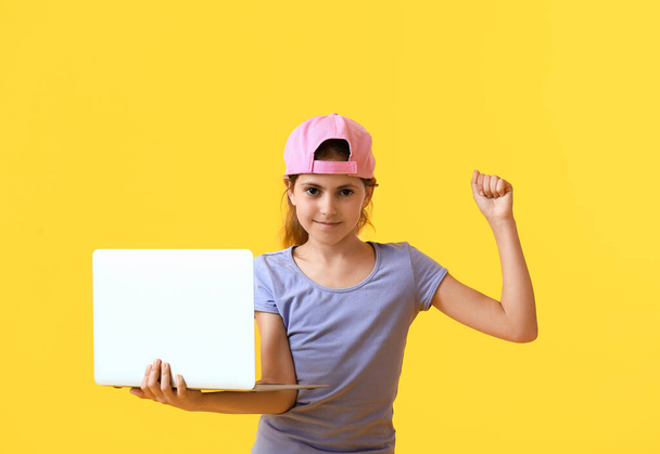 Little programmer with laptop on color background - Zdjęcie, obraz