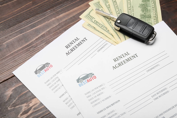 Rental agreements, car key and money on wooden background, closeup - Photo, Image