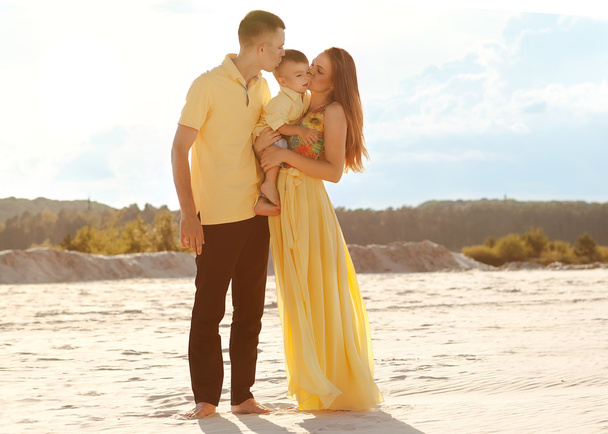Happy beautiful family on the beach sunset  - Fotografie, Obrázek