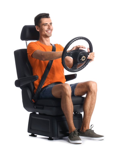 Man in car seat and with steering wheel on white background - Photo, Image