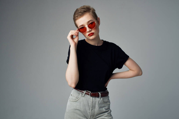short haired woman with sunglasses posing on  isolated background. High quality photo - Φωτογραφία, εικόνα