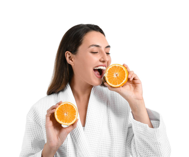 Beautiful young woman with fresh orange on white background - Фото, зображення