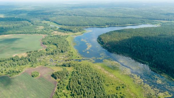 Russia, Ural. Takeoff over fields and forests. Swampy Pond. Clouds with gaps, Aerial View   - Photo, Image